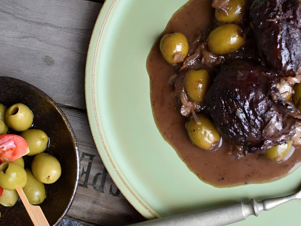 Pork Cheeks with Olives and Tomatoes in Red Wine