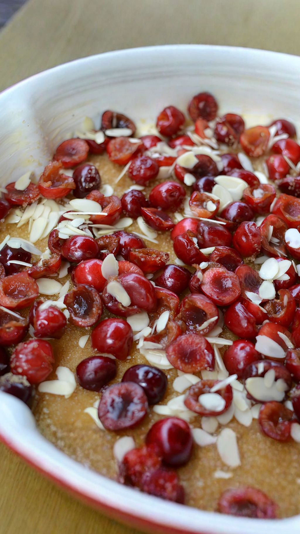 Layer the tin with caramel, cherries and almonds